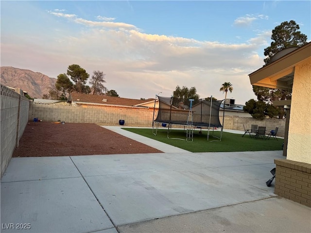 706 Red Lake Way, Las Vegas, NV 89110 - fenced backyard with a trampoline and a patio area