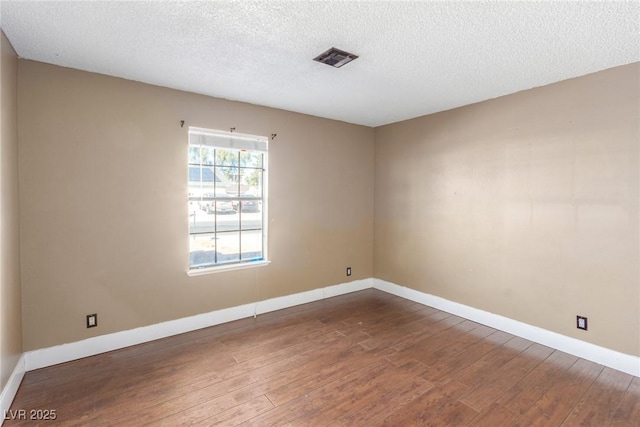 5905 Paseo Montana, Las Vegas, NV 89108 - empty room with dark wood-style flooring and a textured ceiling