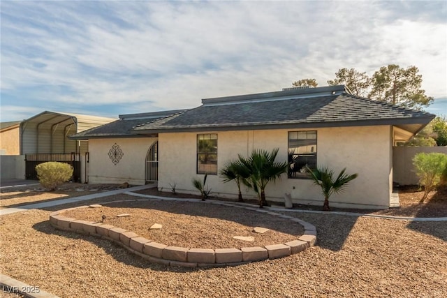 5905 Paseo Montana, Las Vegas, NV 89108 - view of front facade featuring stucco siding, roof with shingles, and a carport