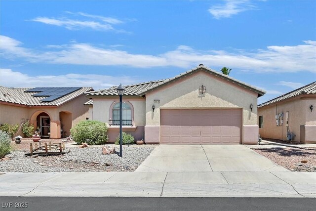 5918 Terra Grande Ave, Las Vegas, NV 89122 - mediterranean / spanish house with a garage, driveway, stucco siding, and a tiled roof