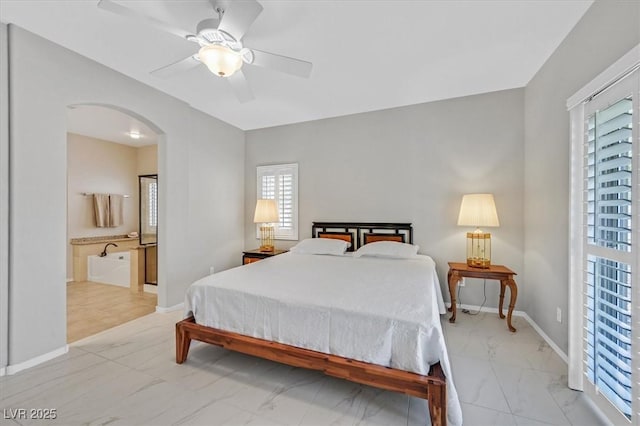 5918 Terra Grande Ave, Las Vegas, NV 89122 - bedroom with light marble finish floors, arched walkways, multiple windows, and a ceiling fan