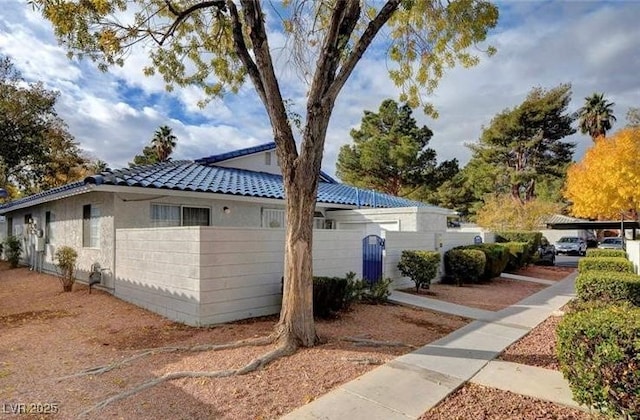 2132 Chertsey Dr Unit B, Las Vegas, NV 89108 - view of home's exterior with a tile roof and stucco siding