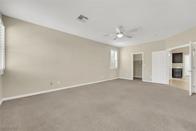 2262 Alanhurst Dr, Henderson, NV 89052 - unfurnished bedroom with light colored carpet, a walk in closet, ceiling fan, and a closet