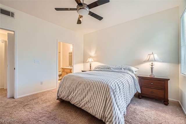 9050 Warm Springs Rd Unit 2050, Las Vegas, NV 89148 - bedroom with light carpet, ensuite bathroom, and a ceiling fan