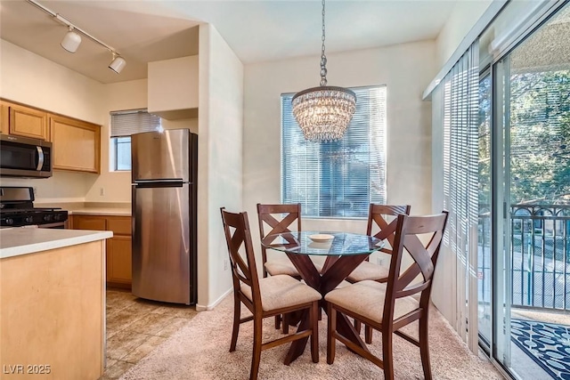 9050 Warm Springs Rd Unit 2050, Las Vegas, NV 89148 - dining space with rail lighting, a chandelier, and light tile patterned floors