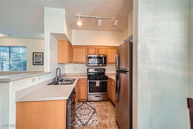 9050 Warm Springs Rd Unit 2050, Las Vegas, NV 89148 - kitchen featuring appliances with stainless steel finishes, track lighting, light countertops, a peninsula, and light tile patterned flooring