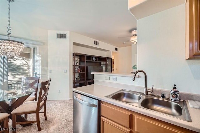 9050 Warm Springs Rd Unit 2050, Las Vegas, NV 89148 - kitchen with stainless steel dishwasher, a chandelier, carpet flooring, light countertops, and pendant lighting