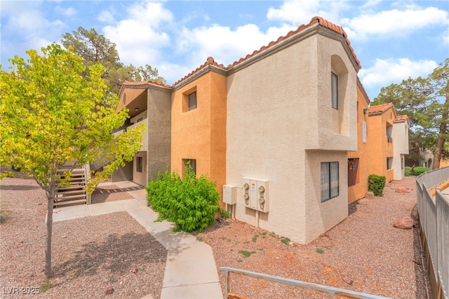 3151 Soaring Gulls Dr Unit 2180, Las Vegas, NV 89128 - view of property exterior featuring stucco siding and a tile roof