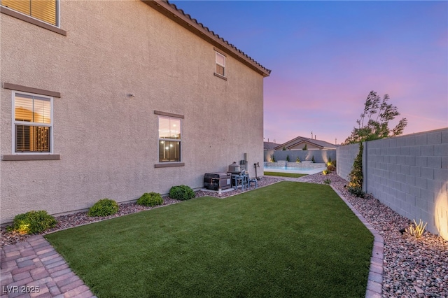 2833 Sangro Ct, Henderson, NV 89044 - yard at dusk featuring a fenced backyard and a patio area