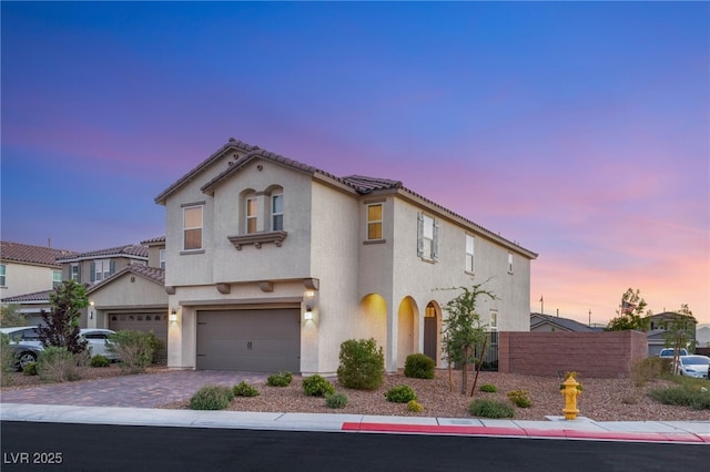 2833 Sangro Ct, Henderson, NV 89044 - mediterranean / spanish-style home with stucco siding, an attached garage, and driveway