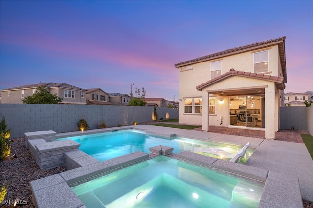 2833 Sangro Ct, Henderson, NV 89044 - pool at dusk with a fenced backyard, a pool with connected hot tub, and a patio area