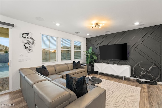 2833 Sangro Ct, Henderson, NV 89044 - living area with wood finished floors, an accent wall, and recessed lighting