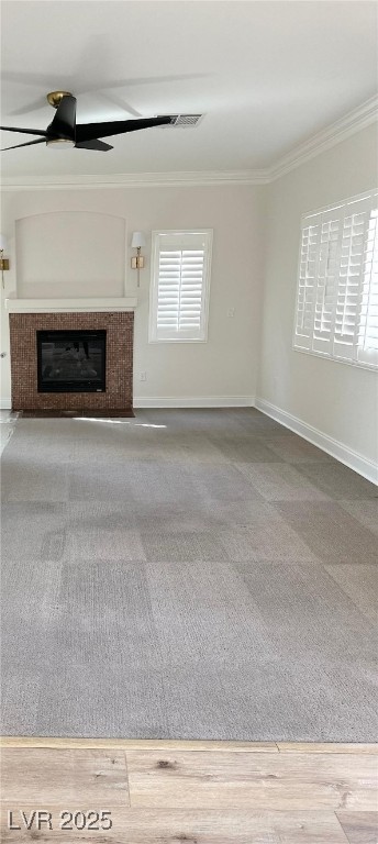 776 Tillis Pl, Las Vegas, NV 89138 - unfurnished living room with ornamental molding, a ceiling fan, a glass covered fireplace, and carpet