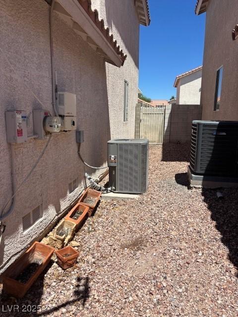 9940 Trailing Vine St, Las Vegas, NV 89183 - view of side of home featuring a cooling unit and stucco siding