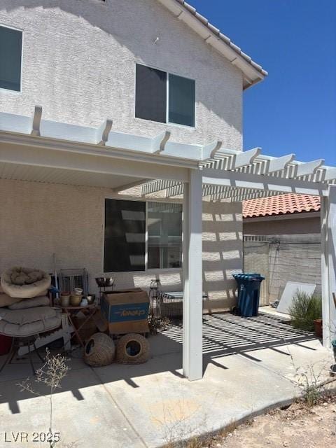 9940 Trailing Vine St, Las Vegas, NV 89183 - rear view of property with a patio, a pergola, stucco siding, and a tile roof