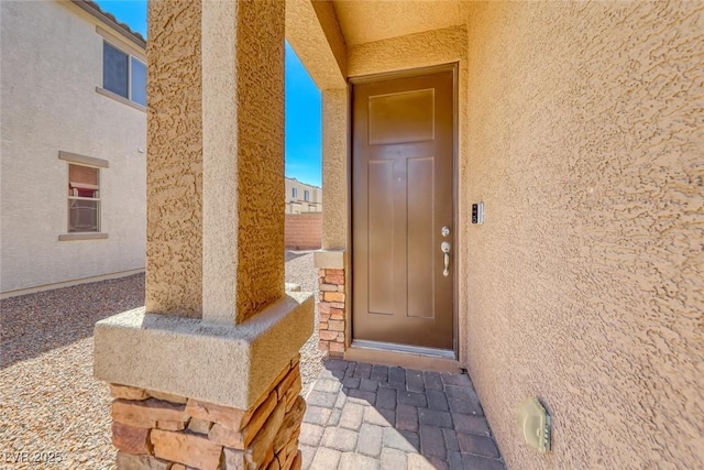6335 Pacific Sky St, North Las Vegas, NV 89081 - doorway to property with stucco siding