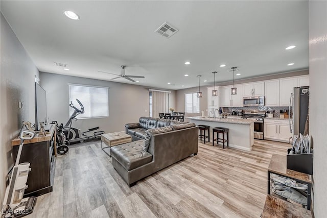 6335 Pacific Sky St, North Las Vegas, NV 89081 - living room with recessed lighting, a ceiling fan, and light wood-style flooring