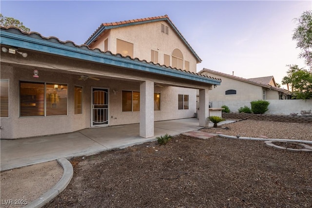 1206 Evening Canyon Ave, Henderson, NV 89014 - back of property featuring stucco siding, a patio area, a tiled roof, and a ceiling fan
