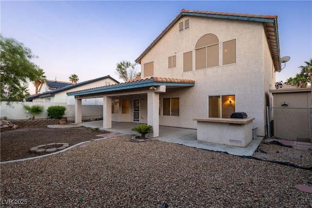 1206 Evening Canyon Ave, Henderson, NV 89014 - rear view of property featuring stucco siding, a patio area, and a tile roof