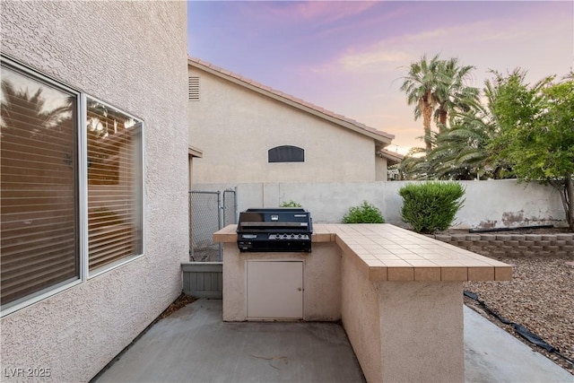 1206 Evening Canyon Ave, Henderson, NV 89014 - patio terrace at dusk with area for grilling and a patio