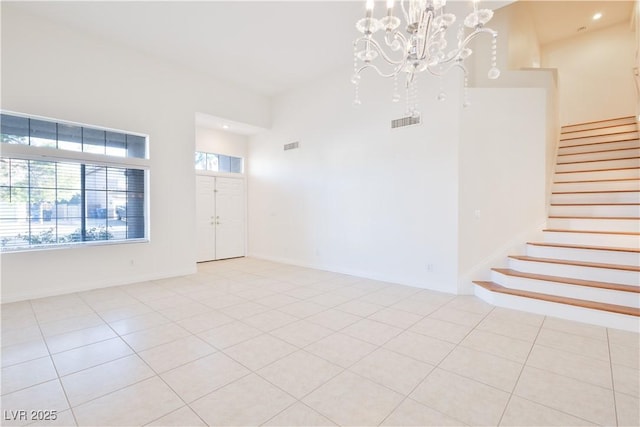 1206 Evening Canyon Ave, Henderson, NV 89014 - spare room with stairs, light tile patterned floors, a chandelier, and recessed lighting