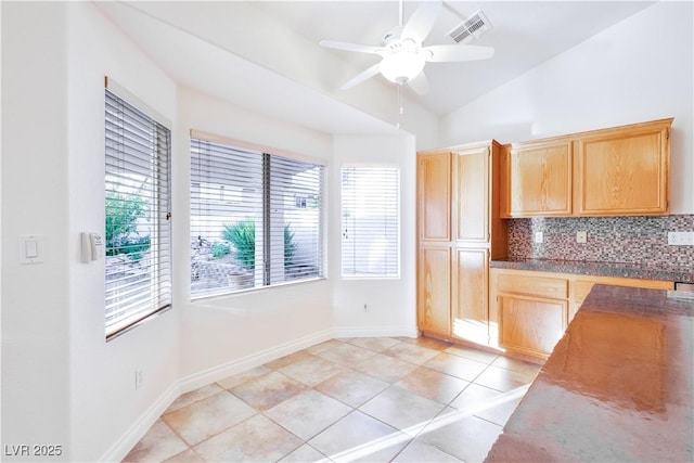 1206 Evening Canyon Ave, Henderson, NV 89014 - kitchen featuring decorative backsplash, plenty of natural light, a ceiling fan, light brown cabinetry, and lofted ceiling