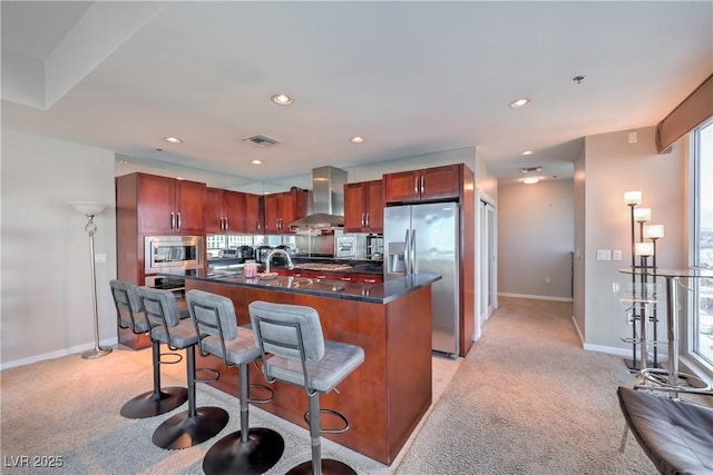 4575 Dean Martin Dr Unit 1112, Las Vegas, NV 89103 - kitchen featuring wall chimney range hood, stainless steel appliances, light colored carpet, dark countertops, and recessed lighting