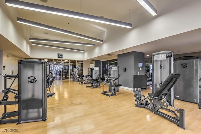 4575 Dean Martin Dr Unit 1112, Las Vegas, NV 89103 - gym featuring wood finished floors and a towering ceiling