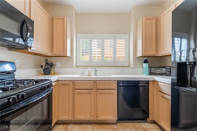 7450 S Eastern Ave Unit 1058, Las Vegas, NV 89123 - kitchen with black appliances, tile counters, light brown cabinets, and light tile patterned floors