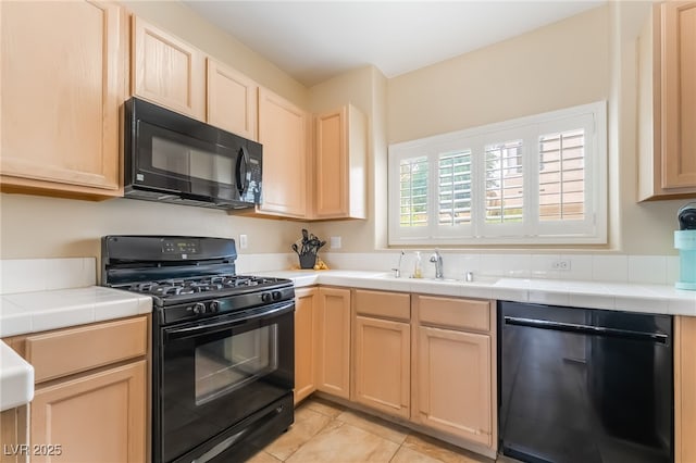 7450 S Eastern Ave Unit 1058, Las Vegas, NV 89123 - kitchen featuring black appliances, tile counters, light brown cabinets, and light tile patterned flooring