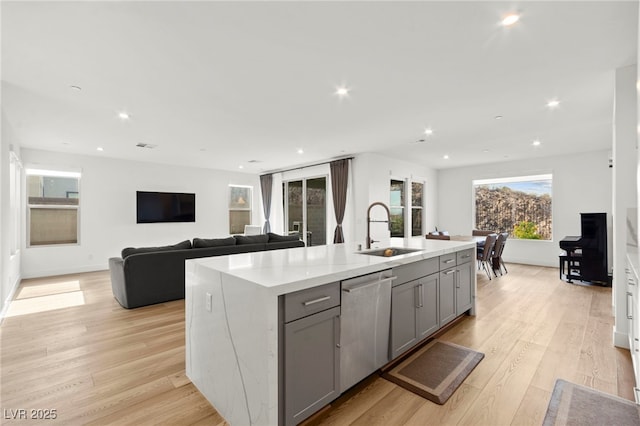 2004 Peaceful Mesa Ct, Henderson, NV 89052 - kitchen with dishwasher, gray cabinetry, light wood-style floors, an island with sink, and recessed lighting