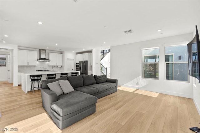2004 Peaceful Mesa Ct, Henderson, NV 89052 - living area featuring light wood-type flooring, recessed lighting, and stairway