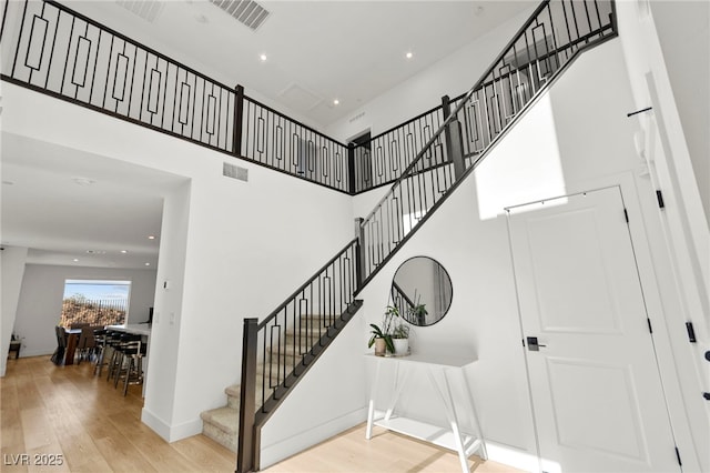 2004 Peaceful Mesa Ct, Henderson, NV 89052 - staircase featuring hardwood / wood-style floors, a towering ceiling, and recessed lighting