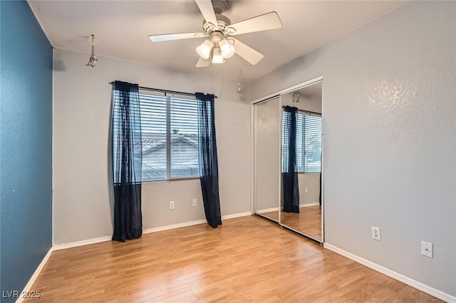 1325 Baychester Dr, Henderson, NV 89002 - unfurnished bedroom featuring multiple windows, light wood-style floors, and a closet