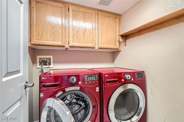 1325 Baychester Dr, Henderson, NV 89002 - laundry area featuring cabinet space, washing machine and dryer, and a textured wall