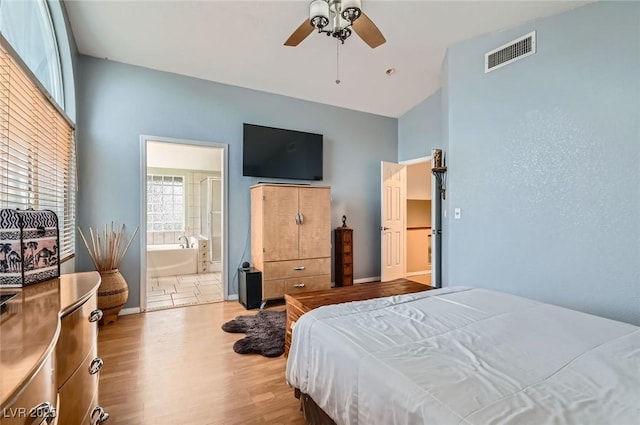 1325 Baychester Dr, Henderson, NV 89002 - bedroom featuring light wood finished floors, ceiling fan, and ensuite bath