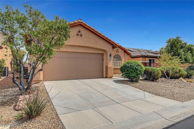 3544 Tack St, Las Vegas, NV 89122 - mediterranean / spanish home featuring a garage, stucco siding, concrete driveway, and a tiled roof