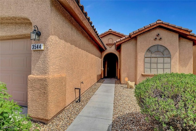 3544 Tack St, Las Vegas, NV 89122 - view of exterior entry with stucco siding and a tiled roof
