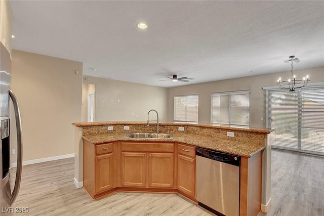 3544 Tack St, Las Vegas, NV 89122 - kitchen with appliances with stainless steel finishes, light wood-type flooring, ceiling fan, light stone countertops, and a chandelier
