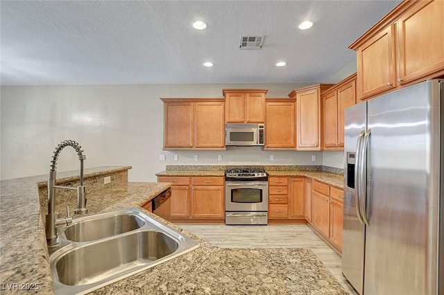 3544 Tack St, Las Vegas, NV 89122 - kitchen with stainless steel appliances, light wood-type flooring, recessed lighting, and a textured ceiling