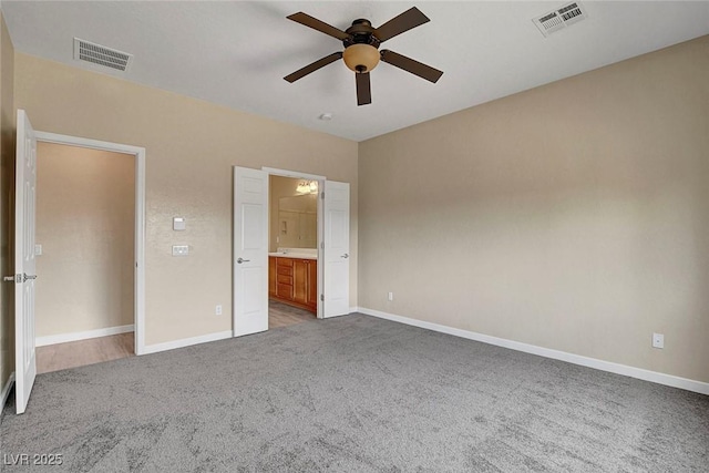 3544 Tack St, Las Vegas, NV 89122 - unfurnished bedroom featuring carpet flooring, connected bathroom, and a ceiling fan