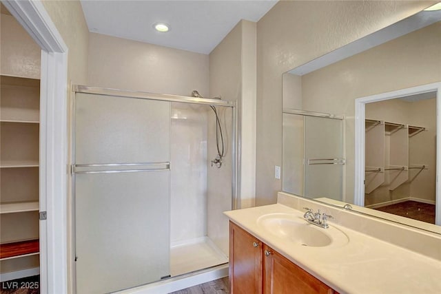 3544 Tack St, Las Vegas, NV 89122 - full bath with a walk in closet, vanity, a stall shower, and wood finished floors
