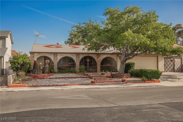 6513 Hyde Ave, Las Vegas, NV 89107 - view of front of home with a garage, driveway, stucco siding, and a porch