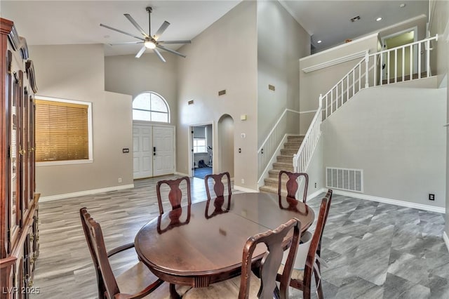 3525 Dover Bay St, Las Vegas, NV 89129 - dining room featuring a ceiling fan, stairs, a towering ceiling, and arched walkways