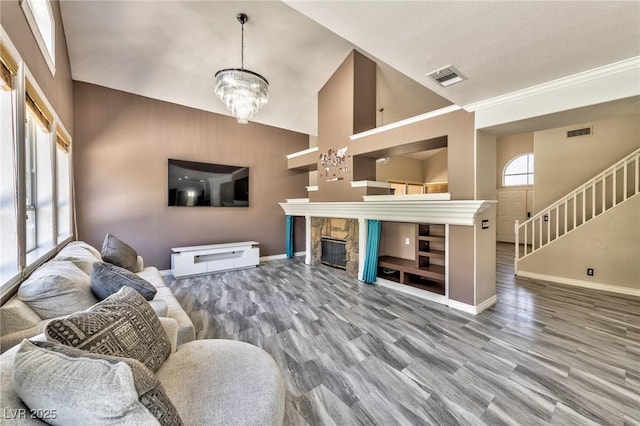 3525 Dover Bay St, Las Vegas, NV 89129 - living area with a chandelier, stairway, wood finished floors, high vaulted ceiling, and a fireplace