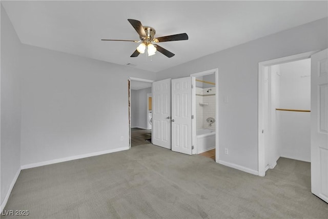 75 N 27th St, Las Vegas, NV 89101 - unfurnished bedroom featuring a spacious closet, carpet floors, a closet, ensuite bath, and a ceiling fan