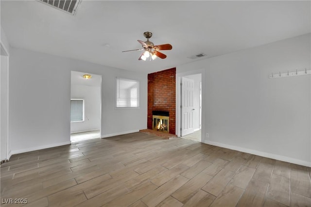75 N 27th St, Las Vegas, NV 89101 - unfurnished living room with a ceiling fan, wood finished floors, and a fireplace
