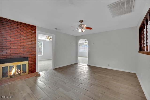 75 N 27th St, Las Vegas, NV 89101 - unfurnished living room featuring ceiling fan, healthy amount of natural light, and wood finished floors