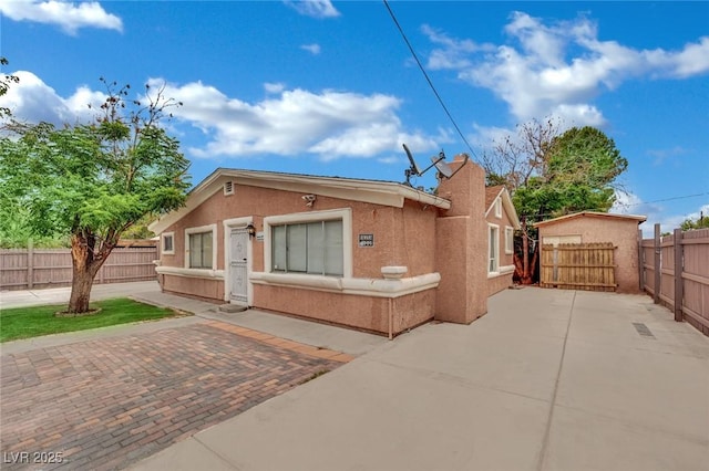 75 N 27th St, Las Vegas, NV 89101 - view of front facade with a patio area, stucco siding, and a fenced backyard