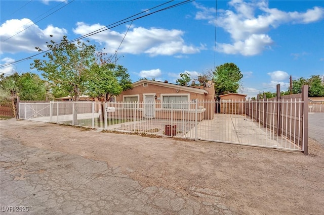 75 N 27th St, Las Vegas, NV 89101 - view of front of home featuring stucco siding, a fenced front yard, and a gate